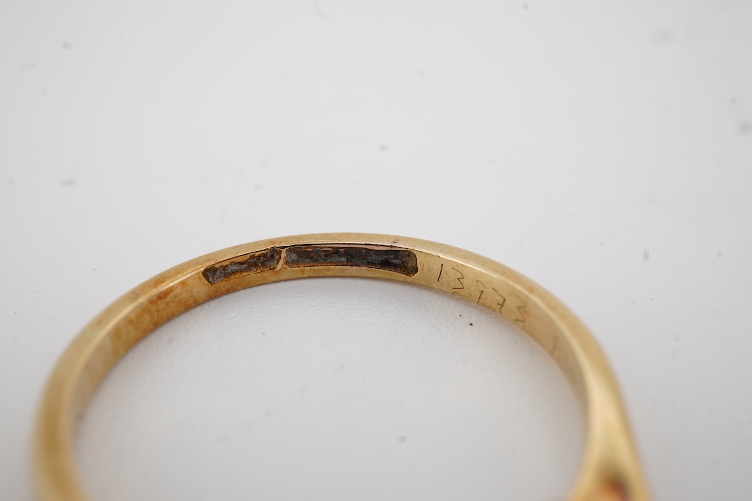 An 18ct, plat. and three stone diamond set ring, size O, gross weight 2.4 grams.